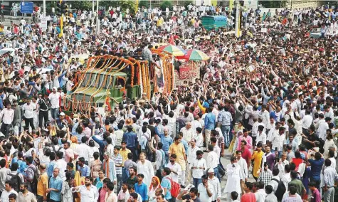  ?? Reuters ?? Crowd gathers around the hearse carrying the body of former prime minister Atal Bihari Vajpayee, on the route to the cremation site in New Delhi yesterday. The three-time prime minister passed away at the age of 93 on Thursday.