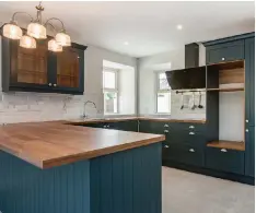  ??  ?? The kitchen’s dark blue cabinets and (left) Rathmiles House is on 3.68 acres