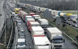  ??  ?? Lorries parked between junction 11 and 12 on the M20 at Folkestone during Operation Stack