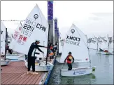  ?? PHOTOS PROVIDED TO CHINA DAILY ?? From left: A beach volleyball match is held in Xiamen, a city rich in natural beach resources. A boy sets sail under the guidance of a coach in Xiamen.