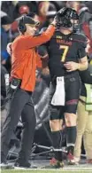  ?? GAIL BURTON/ASSOCIATED PRESS ?? Maryland coach DJ Durkin and reserve quarterbac­k Caleb Rowe celebrate after a first-half touchdown in Saturday night’s game.