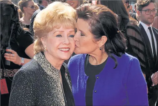  ??  ?? CLOSE FRIENDS: Debbie Reynolds, seen here with Carrie Fisher in 2011, was said to have been overwhelme­d with grief following the death of her daughter on Tuesday.