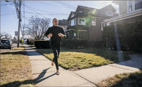  ?? PHOTOS BY JOE BUGLEWICZ — THE NEW YORK TIMES ?? Joseph Deruvo Jr. runs barefoot last month near his home in Norwalk, Conn. Deruvo has lived a mostly barefooted life for nearly two decades. The experience has given him a thick skin.