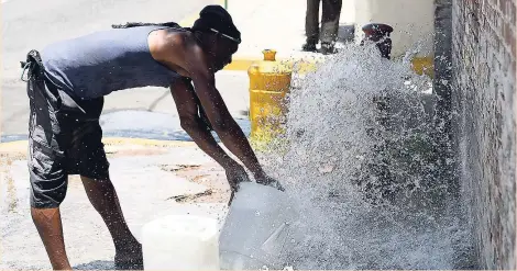  ?? RICARDO MAKYN ?? After this hydrant was opened on North Street yesterday, this man took advantage of the opportunit­y to fill up his bottles. Much of the island is experienci­ng drought conditions currently.