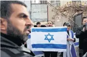  ?? REUTERS ?? Israeli right-wing activists hold an Israeli flag during a counter-protest while Palestinia­n and pro-Palestine activists rally at Jerusalem’s Sheikh Jarrah area.