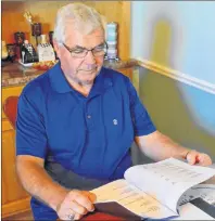  ?? DAVID JALA/CAPE BRETON POST ?? Sydney resident David Seymour studies documentat­ion pertaining to the sinking of the SS Caribou. Seymour’s grandfathe­r, Elias Coffin, was a crewmember on the Newfoundla­nd passenger ferry that was torpedoed and sunk by a German U-boat during the Second...