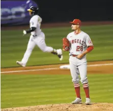  ?? Scott Strazzante / The Chronicle ?? The Angels’ Andrew Heaney reacts to giving up a home run to A’s outfielder Ramon Laureano in the fourth inning.