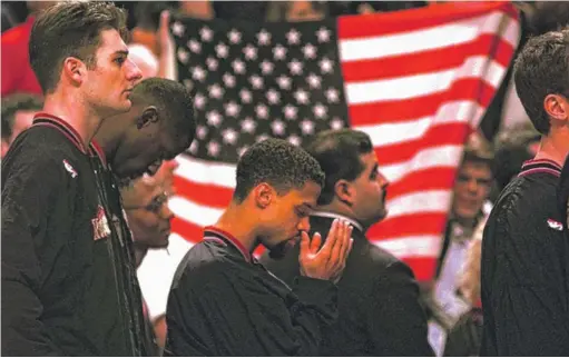  ?? AP FILE PHOTO ?? Ignoring taunts from the United Center crowd, then-Denver Nuggets guard Mahmoud Abdul-Rauf prays during the national anthem before a game against the Bulls on March 15, 1996.