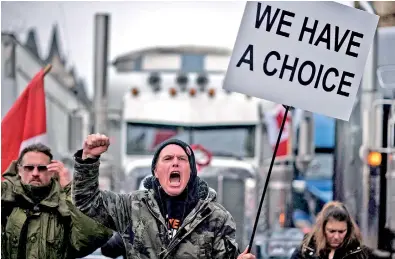  ?? ?? A protester shouts slogans during a protest by truck drivers over pandemic health rules and the Trudeau government, outside the parliament of Canada in Ottawa. (AFP)