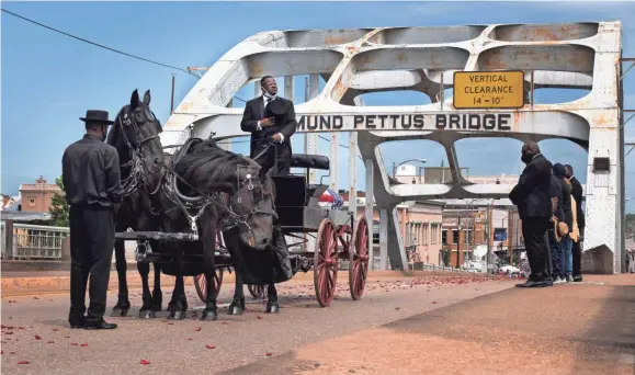  ?? GEORGE WALKER IV / USA TODAY NETWORK ?? U.S. Congressma­n and civil rights icon John Lewis crosses the Edmund Pettus Bridge during his celebratio­n of life ceremonies Sunday in Selma, Ala.