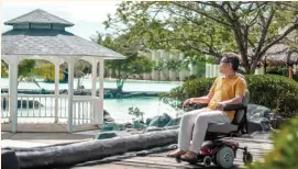  ??  ?? POWER CHAIR. Resort grounds are safe and wheelchair-accessible.