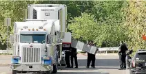  ?? PHOTO: REUTERS ?? Police officers work on a crime scene after eight people believed to be illegal immigrants were found dead inside a sweltering 18-wheeler trailer in San Antonio, Texas. A ninth has died in hospital.