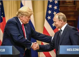  ?? CHRIS MCGRATH / GETTY IMAGES ?? U.S. President Donald Trump (left) and Russian President Vladimir Putin shake hands during a joint press conference after their summit July 16 in Helsinki, Finland. The two leaders met one-on-one and discussed a range of issues.