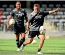  ??  ?? Mitchell Hunt practises his kicking as Aaron Smith looks on at Forsyth Barr Stadium.