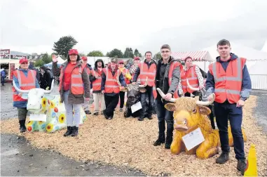  ??  ?? Welcome donation Members of Strathearn Building Bridges, pictured at Crieff Highland Gahthering in 2019