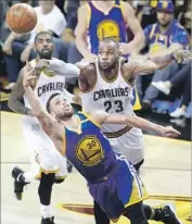  ?? Ron Schwane Associated Press ?? GOLDEN STATE’S Stephen Curry tries to get a shot off against LeBron James during the second half.