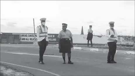  ??  ?? Ranks of the Guyana Police Force on guard at the intersecti­on of the Kitty Roundabout and the seawall road yesterday afternoon.