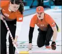  ?? AARON FAVILA/AP ?? Becca and Matt Hamilton compete in mixed doubles curling against Switzerlan­d, which stunned them in the final end.