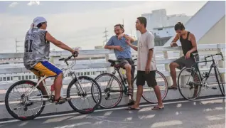  ?? PHOTOGRAPH BY RIO DELUVIO FOR THE DAILY TRIBUNE @tribunephl_rio ?? CYCLISTS stop at the Binondo-Intramuros bridge for a needed cooling down, early Friday morning.The iconic 680-meter two-way and four-lane bridge, which is a tied-arch bridge that spans the Pasig River, was opened to traffic on 6 April 2022.