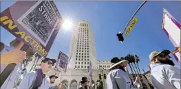  ?? Gary Coronado Los Angeles Times ?? CITY workers picket at L.A. City Hall during their 24-hour work stoppage.
