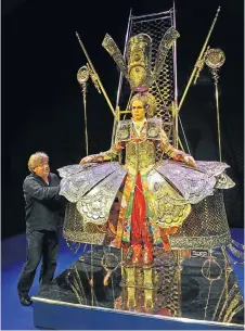  ?? Picture: GLENN COPUS ?? OBSESSED BY THE EPIC: Designer Johan Engels puts opera singer Christophe­r Ainslie into the king’s costume for ‘Artaxerxes’