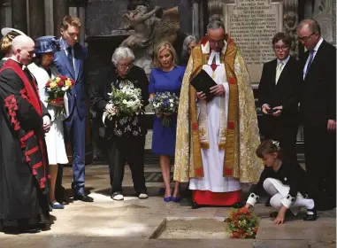  ??  ?? Hawking’s ashes are interred, watched over by his family and the Dean of Westminste­r (third from right)