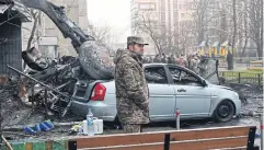  ?? AFP ?? A soldier stands at the site where a helicopter crashed in Kyiv yesterday.