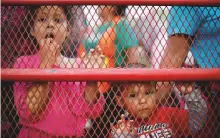  ?? Reuters ?? Migrant children, part of a caravan travelling from Central America en route to the United States, look from a truck after resting in a makeshift camp on Friday.