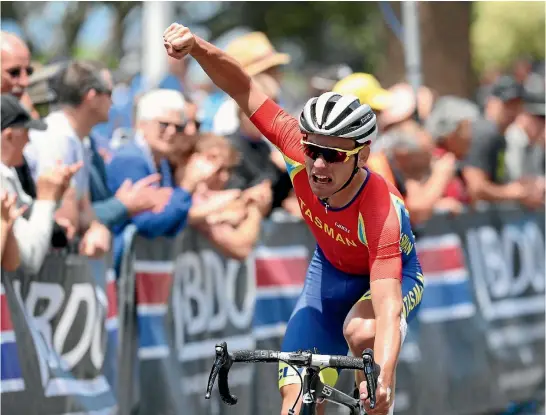  ??  ?? Tasman rider Jason Christie celebrates winning his second national road championsh­ip in three years, in Napier yesterday.