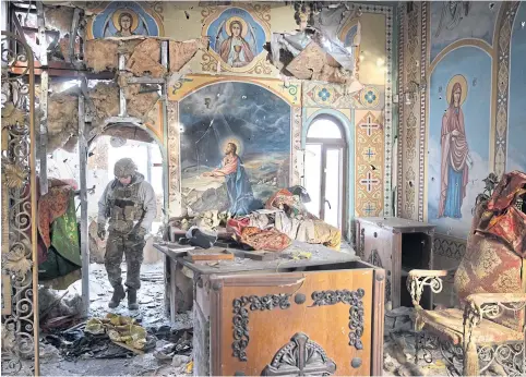  ?? ?? A Ukrainian soldier is seen in a church hit by shelling and reportedly looted by Russians during their occupation, in the Lyman district, Donetsk region on Dec 25.