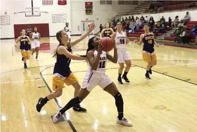  ?? Staff photo by Brian Tyl ?? ■ Arkansas High’s Starjah Taylor drives in for a layup as a Bradley player tries to defend in a girls varsity basketball game on Tuesday at Razorback Gym in Texarkana, Ark.