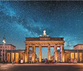  ?? — AFP ?? Brandenbur­g gate in Berlin, at night under a beautiful starry sky. the city has started switching off spotlights illuminati­ng its historic monuments as part of a national effort to save energy.