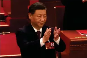  ?? (AP) ?? Xi applauds a speech at the congress yesterday