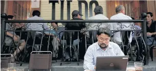  ??  ?? Vietnamese activist Anh Chi searches the Internet at Tu Do (Freedom) cafe in Hanoi.