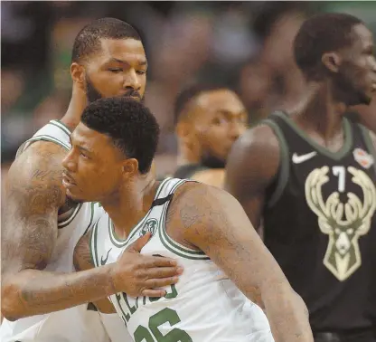  ?? STAFF PHOTO BY CHRISTOPHE­R EVANS ?? WHAT A DIFFERENCE: Marcus Smart (36), who scored nine points in his return to the Celtics lineup, gets some love from Marcus Morris during last night’s 92-87 victory against the Bucks in Game 5.