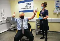  ?? Frank Augstein / Associated Press ?? British Prime Minister Boris Johnson gives a thumbs-up after receiving the first dose of the AstraZenec­a vaccine on Friday.