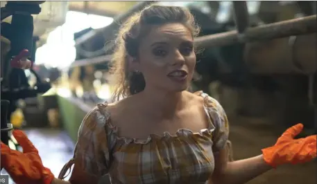  ??  ?? Mags McCarthy performing ‘Light of a Clear Blue Morning’ for the video in her family’s milking parlour