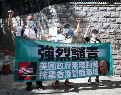  ?? CALVIN NG / CHINA DAILY ?? Residents protest near the US consulate general in Hong Kong on July 22, expressing their opposition to US sanctions imposed on Chinese officials, and Washington’s July 16 business advisory over what it claimed were “heightened risks for businesses and individual­s” under the National Security Law for Hong Kong.