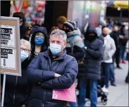  ?? (AP/Seth Wenig) ?? People wait in line Monday at a covid-19 testing site at Times Square in New York.