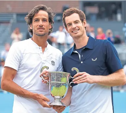  ?? Picture: Getty Images. ?? Andy Murray, right, and doubles partner Feliciano Lopez, of Spain, with the trophy after winning the title at Queen’s Club in London.