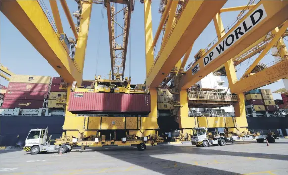  ?? Reuters ?? Terminal tractors line up as they are loaded with containers from a cargo ship at DP World’s Terminal 2 at Jebel Ali Port in Dubai