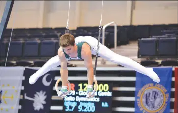  ?? Courtesy photo ?? Troy Lipis of Trinity Classical Academy demonstrat­ing his athletic ability on the still rings.