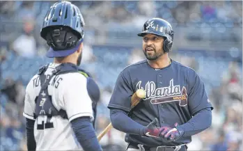  ?? DENIS POROY / GETTY IMAGES ?? In his first game in San Diego after being traded from the Padres to the Braves, Matt Kemp chats with Padres catcher Luis Torrens as he comes up to bat amid a chorus of boos from fans at Petco Park.