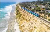  ?? U-T FILE ?? Coaster commuter trains, Amtrak trains and BNSF freight trains all use the tracks through Del Mar.