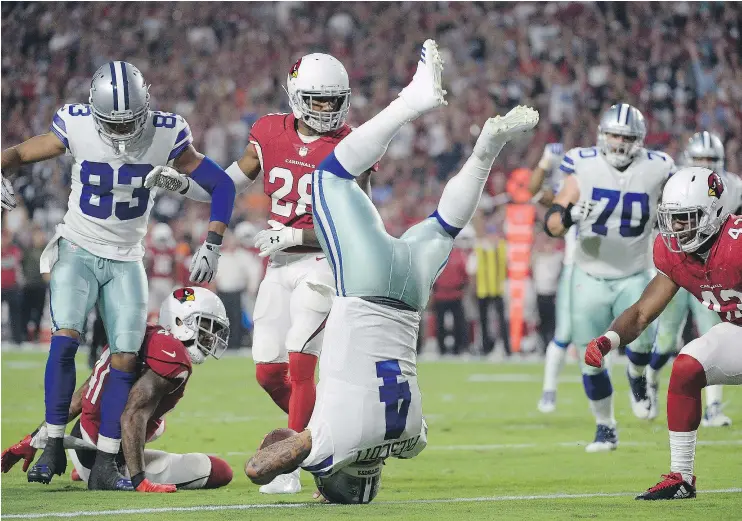  ?? — GETTY IMAGES ?? Dallas Cowboys quarterbac­k Dak Prescott dove headfirst into the end zone to score a touchdown in a 28-17 win over the Arizona Cardinals Monday in Glendale.