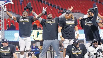  ?? JOHN BAZEMORE/ASSOCIATED PRESS ?? Members of the Central Florida football team celebrate after they defeated Auburn in the Peach Bowl. The Knights went undefeated this season and are staking claim to the title of 2017 national champs.