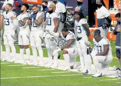  ?? AP ?? Members of the Tennessee Titans are seen prior to Sunday’s game against the Minnesota Vikings. The NFL says the Titans and Vikings are suspending in-person activities after the Titans had three players test positive for the coronaviru­s, along with five other personnel members.