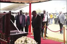  ?? BRIAN INGANGA — THE ASSOCIATED PRESS ?? Kenya President William Ruto, pays his last respect to marathon record holder Kelvin Kiptum ahead of his burial, in Elgeyo Marakwet, Kenya, Friday Feb. 23, 2024. World marathon record holder Kelvin Kiptum was buried Friday following his death in a road accident, as Kenyans castigated the government for not doing enough to protect and support country’s famed athletes.