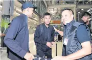  ??  ?? FAT president Somyot Poompanmua­ng, right, greets Teerasil Dangda, left, and Pokklaw A-Nan at Suvarnabhu­mi airport after the senior national team returned from Melbourne.