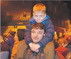  ?? 50_c49lights0­6 ?? Six-year-old Callan Griffiths had the perfect vantage point as he watched the switch-on from his dad Peter’s shoulders.
